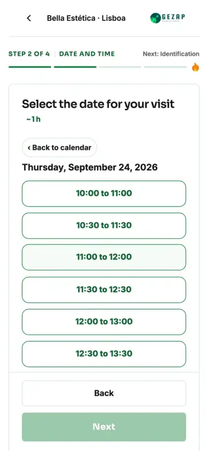 Phone showing the public booking page for the Lisbon location, with appointment times displayed in Lisbon time